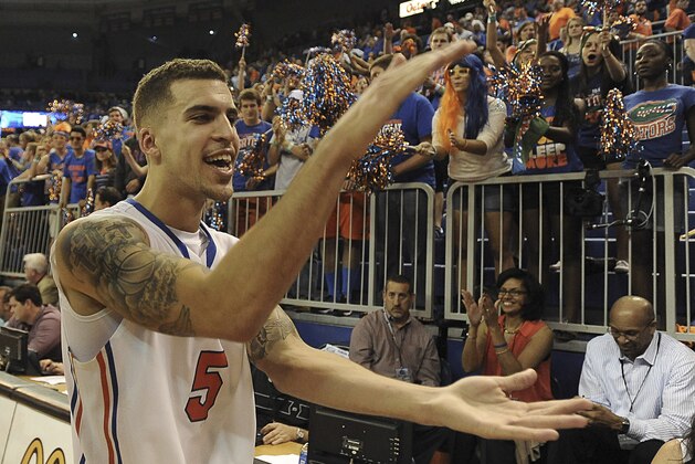 Florida guard Scottie Wilbekin (5) does the gator chomp as he leaves the court after Florida defeated LSU 79-61 in an NCAA college basketball game Saturday, March 1, 2014 in Gainesville, Fla.  (AP Photo/Phil Sandlin)