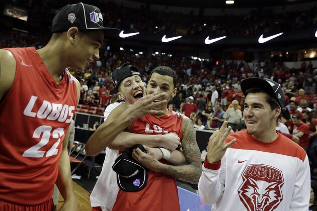 New Mexico's  Kendall Williams, center front, celebrates with teammates after winning an NCAA college basketball game against San Diego State for the Mountain West Conference tournament championship on Saturday, March 15, 2014, in Las Vegas. New Mexico defeated San Diego State 64-58. (AP Photo/Isaac Brekken)