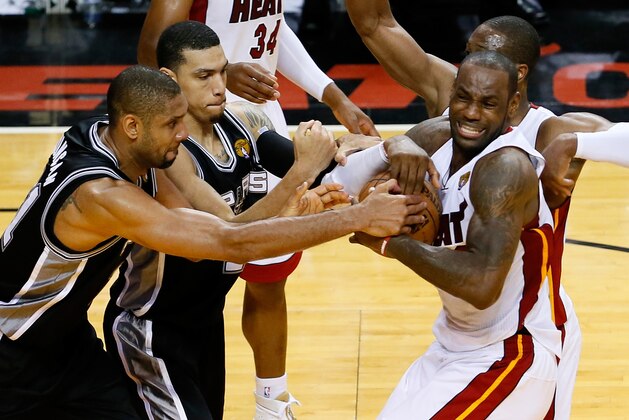 MIAMI, FL - JUNE 18:  Tim Duncan #21 and Danny Green #4 of the San Antonio Spurs battle for the ball against LeBron James #6 and Dwyane Wade #3 of the Miami Heat in overtime during Game Six of the 2013 NBA Finals at AmericanAirlines Arena on June 18, 2013 in Miami, Florida. NOTE TO USER: User expressly acknowledges and agrees that, by downloading and or using this photograph, User is consenting to the terms and conditions of the Getty Images License Agreement.  (Photo by Kevin C. Cox/Getty Images)