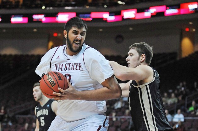 Mar 15, 2014; Las Vegas, NV, USA; New Mexico State Aggies player Sim Bhullar (2) protects the ball against the defense of Idaho Vandals player Joe Kammerer (42) in the championship game for the WAC Conference college basketball tournament at Orleans Arena. Mandatory Credit: Stephen R. Sylvanie-USA TODAY Sports