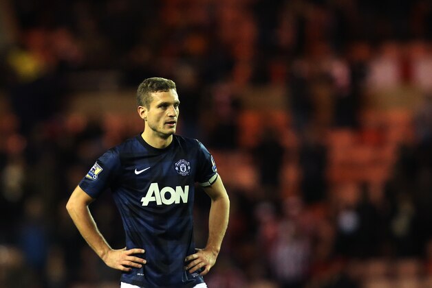 Manchester United's captain Nemanja Vidic stands dejected after being defeated by Sunderland at the end of their English League Cup semifinal first leg soccer match at the Stadium of Light, Sunderland, England, Tuesday, Jan. 7, 2014. (AP Photo/Scott Heppell)