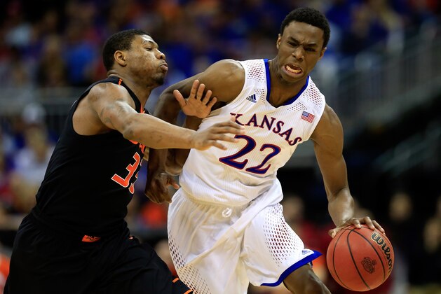 KANSAS CITY, MO - MARCH 13:  Andrew Wiggins #22 of the Kansas Jayhawks drives upcourt as Marcus Smart #33 of the Oklahoma State Cowboys defends during the Big 12 Basketball Tournament quarterfinal game at Sprint Center on March 13, 2014 in Kansas City, Missouri.  (Photo by Jamie Squire/Getty Images)