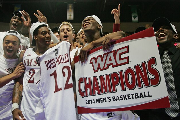 Mar 15, 2014; Las Vegas, NV, USA; The New Mexico State Aggies players celebrate after defeating the Idaho Vandals 77-55 in the championship game for the WAC Conference college basketball tournament at Orleans Arena. Mandatory Credit: Stephen R. Sylvanie-USA TODAY Sports
