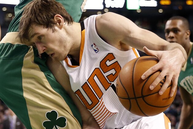 Phoenix Suns guard Goran Dragic of Slovenia drives against the Boston Celtics during the second half of the Suns 87-80 win in an NBA basketball game in Boston Friday, March 14, 2014. (AP Photo/Winslow Townson)