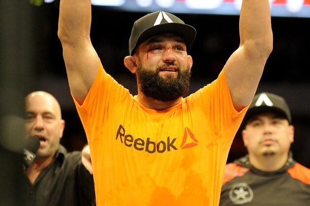 Johny Hendricks celebrates after beating Robbie Lawler during a UFC 171 mixed martial arts welterweight title bout, Saturday, March 15, 2014, in Dallas. Hendricks won by decision. (AP Photo/Matt Strasen)