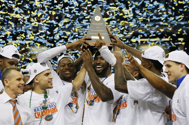 ATLANTA, GA - MARCH 16:  The Florida Gators celebrate with the trophy after their 61 to 60 win over the Kentucky Wildcats in the Championship game of the 2014 Men's SEC Basketball Tournament at Georgia Dome on March 16, 2014 in Atlanta, Georgia.  (Photo by Kevin C. Cox/Getty Images)