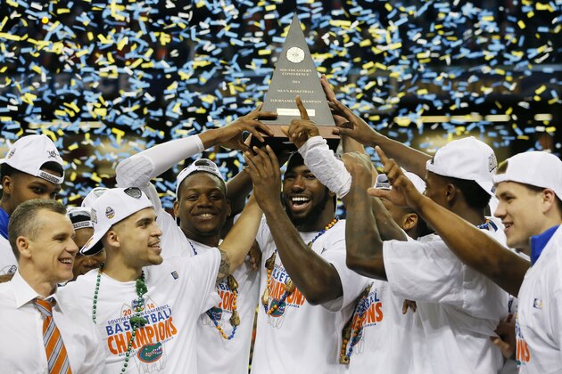 ATLANTA, GA - MARCH 16:  The Florida Gators celebrate with the trophy after their 61 to 60 win over the Kentucky Wildcats in the Championship game of the 2014 Men's SEC Basketball Tournament at Georgia Dome on March 16, 2014 in Atlanta, Georgia.  (Photo by Kevin C. Cox/Getty Images)