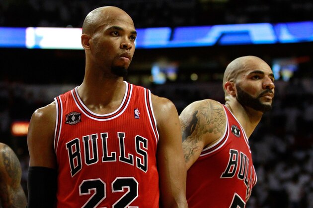 MIAMI, FL - MAY 22:  (L-R) Taj Gibson #22 and Carlos Boozer #5 of the Chicago Bulls look on against the Miami Heat in Game Three of the Eastern Conference Finals during the 2011 NBA Playoffs on May 22, 2011 at American Airlines Arena in Miami, Florida.  NOTE TO USER: User expressly acknowledges and agrees that, by downloading and or using this photograph, User is consenting to the terms and conditions of the Getty Images License Agreement.  (Photo by Marc Serota/Getty Images)