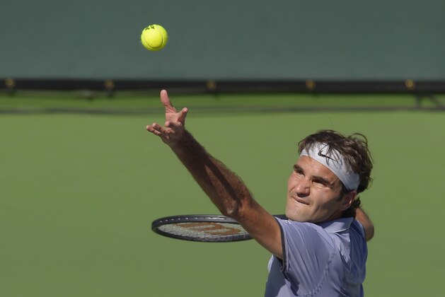 Roger Federer, of Switzerland, serves to Novak Djokovic, of Serbia, in the final match of the BNP Paribas Open tennis tournament, Sunday, March 16, 2014, in Indian Wells, Calif. (AP Photo/Mark J. Terrill)