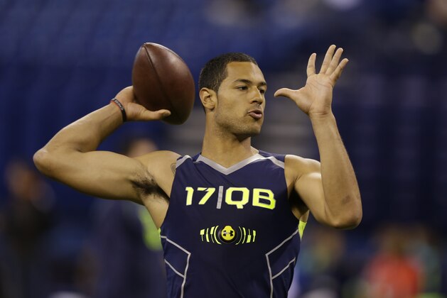 Virginia Tech quarterback Logan Thomas throws during a drill at the NFL football scouting combine in Indianapolis, Sunday, Feb. 23, 2014. (AP Photo/Michael Conroy)