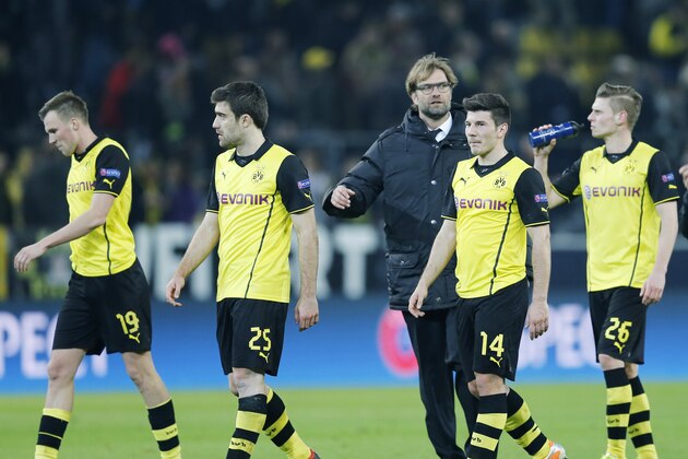 Dortmund head coach Juergen Klopp, center, and his players walk on the pitch after the Champions League round of 16 second leg soccer match between Borussia Dortmund and FC Zenit in Dortmund, Germany, Wednesday, March19,2014. (AP Photo/Frank Augstein)