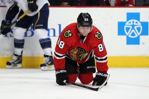 CHICAGO, IL - MARCH 19: Patrick Kane #88 of the Chicago Blackhawks is slow to get up after suffering an apparent injury in the second period against the St. Louis Blues at the United Center on March 19, 2014  in Chicago, Illinois. (Photo by Jonathan Daniel/Getty Images)