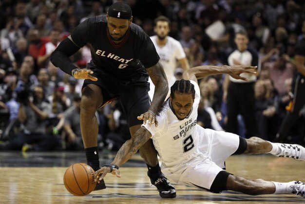 Mar 6, 2014; San Antonio, TX, USA; Miami Heat forward LeBron James (6) and San Antonio Spurs forward Kawhi Leonard (2) battle for a loose ball during the second half at AT&T Center. The Spurs won 111-87. Mandatory Credit: Soobum Im-USA TODAY Sports