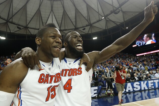 Florida's forward Will Yeguete (15) Patric Young (4) celebrate after the second half of an NCAA college basketball game against Kentucky in the Championship round of the Southeastern Conference men's tournament, Sunday, March 16, 2014, in Atlanta. Florida won 61-60. (AP Photo/John Bazemore)