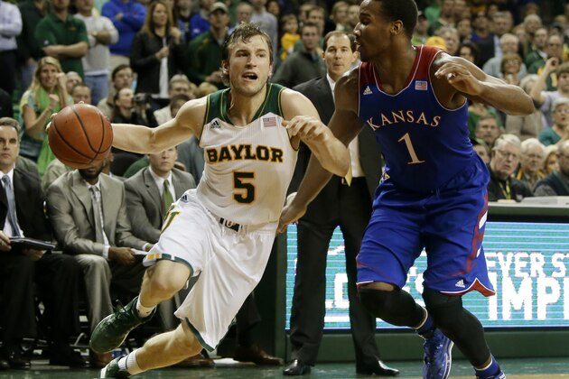 Baylor guard Brady Heslip (5) attempts to get by Kansas' Wayne Selden, Jr. (1) on a drive to the basket in the second half of an NCAA college basketball game, Tuesday, Feb. 4, 2014, in Waco, Texas. Kansas won 69-52.  (AP Photo/Tony Gutierrez)