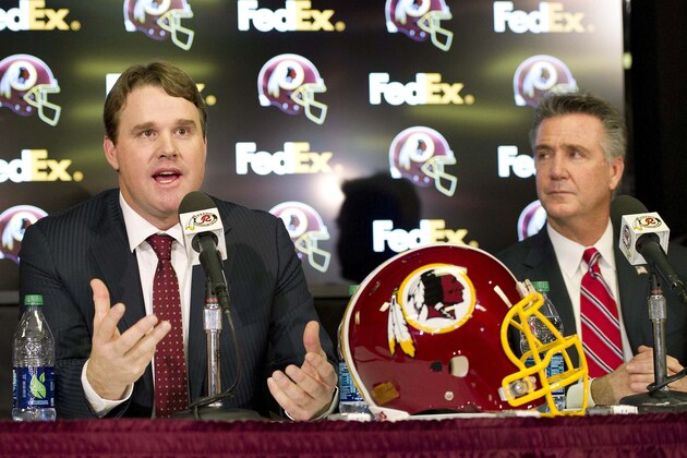 Jan 9, 2014; Ashburn, VA, USA; Washington Redskins head coach Jay Gruden speaks as general manager Bruce Allen looks on during a press conferences at Redskins Park Team Auditorium. Mandatory Credit: Brad Mills-USA TODAY Sports