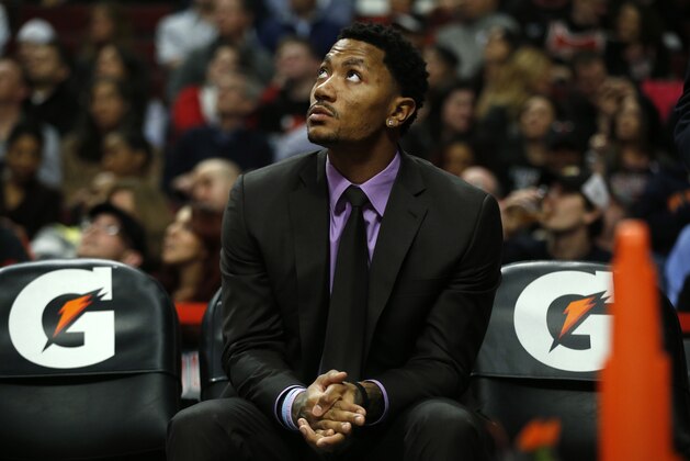 Chicago Bulls Derrick Rose watches the game from the bench against the San Antonio Spurs during the first half of an NBA basketball game on Tuesday, March 11, 2014, in Chicago. The San Antonio Spurs defeated The Chicago Bulls 104-96. (AP Photo/Andrew A. Nelles)