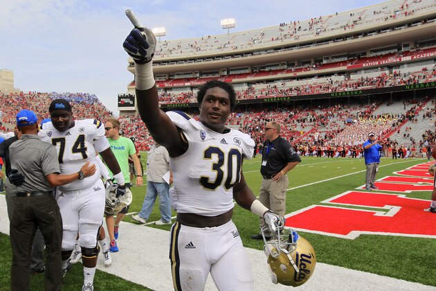 UCLA linebacker Myles Jack (30) celebrates a 41-21 win over Nebraska in an NCAA college football game in Lincoln, Neb., Saturday, Sept. 14, 2013. At left is UCLA guard Caleb Benenoch (74). (AP Photo/Nati Harnik)