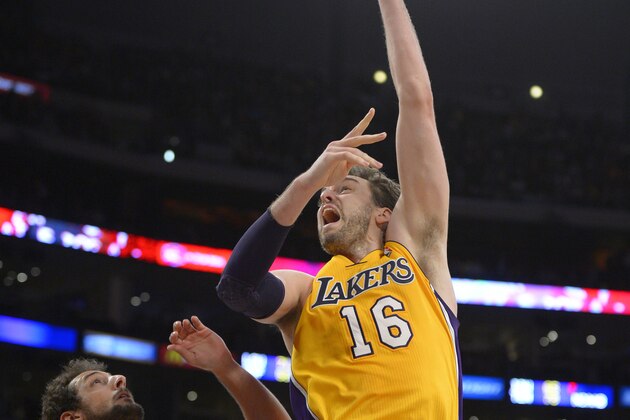 Los Angeles Lakers center Pau Gasol, right, of Spain, puts up a shot as San Antonio Spurs guard Marco Belinelli, of Italy, defends during the second half of their NBA basketball game, Wednesday, March 19, 2014, in Los Angeles. The Spurs won 125-109. (AP Photo/Mark J. Terrill)