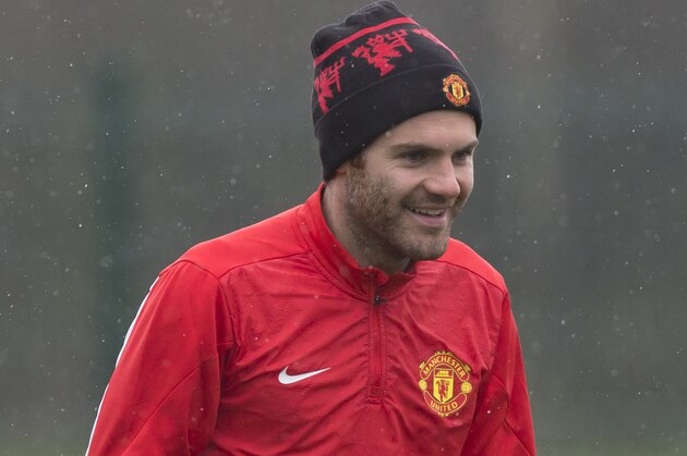 Manchester United's Juan Mata trains with teammates at Carrington training ground in Manchester, Tuesday, March 18, 2014. Manchester United will play Olympiakos in a Champions League last 16 second leg soccer match on Wednesday. (AP Photo/Jon Super) Manchester United's Juan Mata trains with teammates at Carrington training ground in Manchester, Tuesday, March 18, 2014. Manchester United will play Olympiakos in a Champions League last 16 second leg soccer match on Wednesday. (AP Photo/Jon Super)