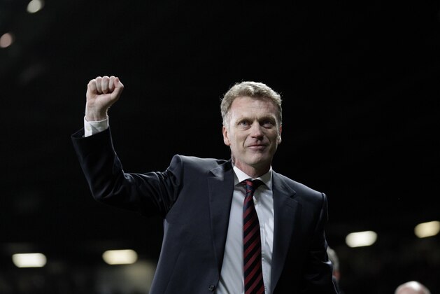Manchester United manager David Moyes celebrates after his team's 3-0 Champions League last 16 second leg soccer match win against Olympiakos at Old Trafford Stadium, Manchester, England, Wednesday, March 19, 2014. (AP Photo/Jon Super)