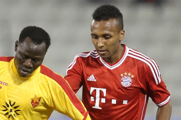 Bayern Munich's Julian Green, right, of Munich and Balla Jabir of Al-Merrikh, challenge for the ball,  during their friendly soccer match, at Al-Saad stadium in Doha Thursday, Jan. 9, 2014. (AP Photo/Osama Faisal)