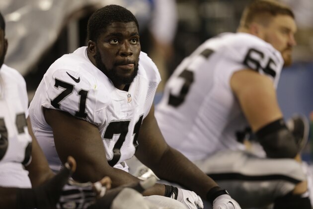 Oakland Raiders' Menelik Watson sits on the sideline in the first half of an NFL preseason football game against the Seattle Seahawks, Thursday, Aug. 29, 2013, in Seattle. (AP Photo/Stephen Brashear)