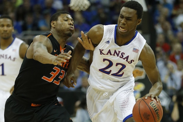 Kansas guard Andrew Wiggins (22) is covered by Oklahoma State guard Marcus Smart (33) during the second half of an NCAA college basketball game in the quarterfinals of the Big 12 Conference men's tournament in Kansas City, Mo., Thursday, March 13, 2014. Kansas defeated Oklahoma State 77-70 in overtime. (AP Photo/Orlin Wagner)