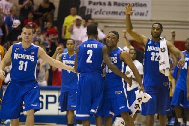 FILE - In this Nov. 22, 2011, file photo, Memphis' Preston Laird (31), Antonio Barton (2), Trey Draper, right center, and  Stan Simpson (32) celebrate their double overtime win in a NCAA college basketball game against Tennessee, in Lahaina, Hawaii. A person familiar with the talks says the Big East is in discussions with Memphis about the Tigers joining the conference in all sports.  The person spoke on the condition of anonymity Tuesday, Feb. 7, 2012, because talks were ongoing between Memphis and the Big East. (AP Photo/Eugene Tanner, File)