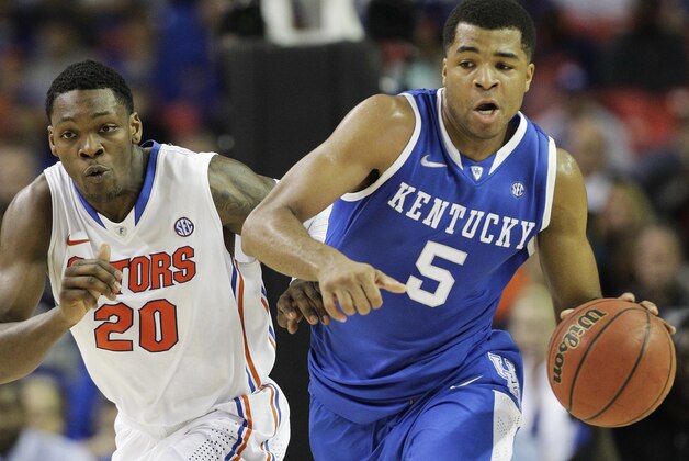 Kentucky guard Andrew Harrison (5) runs on Florida guard Michael Frazier II (20) during the first half of an NCAA college basketball game in the Championship round of the Southeastern Conference men's tournament, Sunday, March 16, 2014, in Atlanta. (AP Photo/Steve Helber)