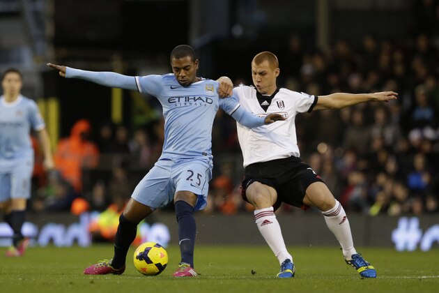 Fulham's Steve Sidwell, right, competes for the ball with Manchester City's Fernandinho during the English Premier League soccer match between Fulham and Manchester City at Craven Cottage stadium in London, Saturday, Dec. 21, 2013.  (AP Photo/Matt Dunham)