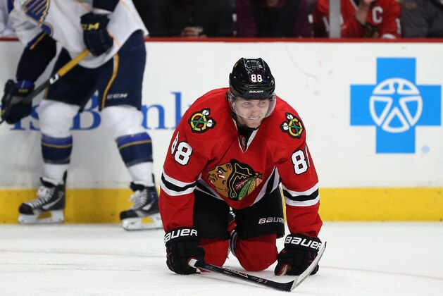 CHICAGO, IL - MARCH 19: Patrick Kane #88 of the Chicago Blackhawks is slow to get up after suffering an apparent injury in the second period against the St. Louis Blues at the United Center on March 19, 2014  in Chicago, Illinois. (Photo by Jonathan Daniel/Getty Images)