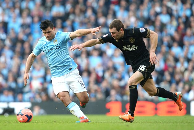 MANCHESTER, ENGLAND - MARCH 09:   Sergio Aguero of Manchester City battles with James McArthur of Wigan Athletic during the FA Cup Quarter-Final match between Manchester City and Wigan Athletic at the Etihad Stadium on March 9, 2014 in Manchester, England.  (Photo by Jan Kruger/Getty Images)