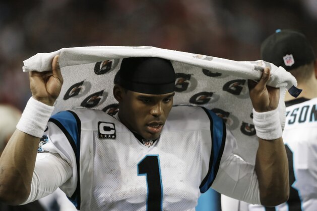 Carolina Panthers quarterback Cam Newton (1) sits on the sidelines during the second half of an NFL football game against the Atlanta Falcons, Sunday, Dec. 29, 2013, in Atlanta. (AP Photo/Dave Martin)