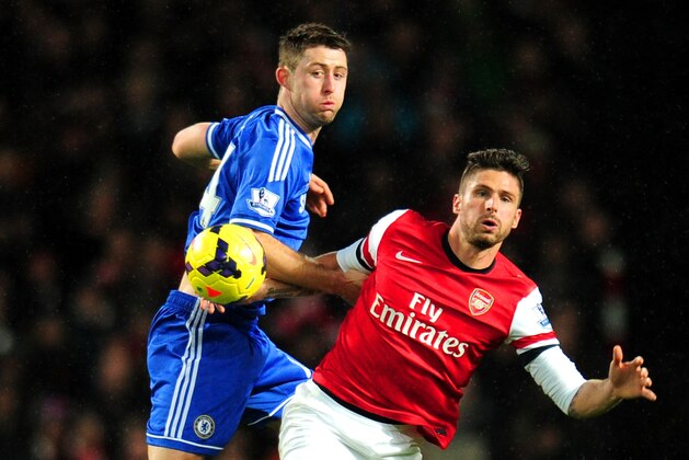 LONDON, ENGLAND - DECEMBER 23:  Gary Cahill of Chelsea and Olivier Giroud of Arsenal compete for the ball during the Barclays Premier League match between Arsenal and Chelsea at Emirates Stadium on December 23, 2013 in London, England.  (Photo by Shaun Botterill/Getty Images)