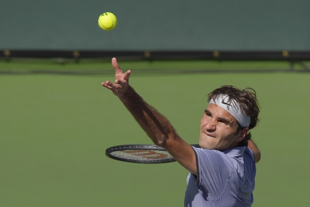 Roger Federer, of Switzerland, serves to Novak Djokovic, of Serbia, in the final match of the BNP Paribas Open tennis tournament, Sunday, March 16, 2014, in Indian Wells, Calif. (AP Photo/Mark J. Terrill)