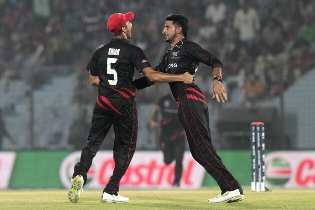 Hong Kong's bowler Nizakat Khan, right and Ehsan Nawaz celebrate the dismissal of Bangladesh's Abdur Razzak during their ICC Twenty20 Cricket World Cup match in Chittagong, Bangladesh, Thursday, March 20, 2014 . (AP Photo/Bikas Das)