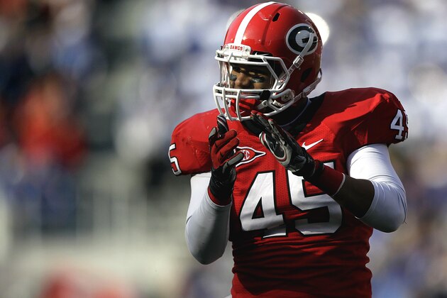 Georgia linebacker Christian Robinson (45) applauds after stopping the Kentucky offense from a first down attempt during the third quarter of an NCAA college football game Saturday, Nov. 19, 2011 in Athens, Ga. No. 13 Georgia beat Kentucky 19-10 to clinch a spot in the SEC championship game. (AP Photo/David Goldman)