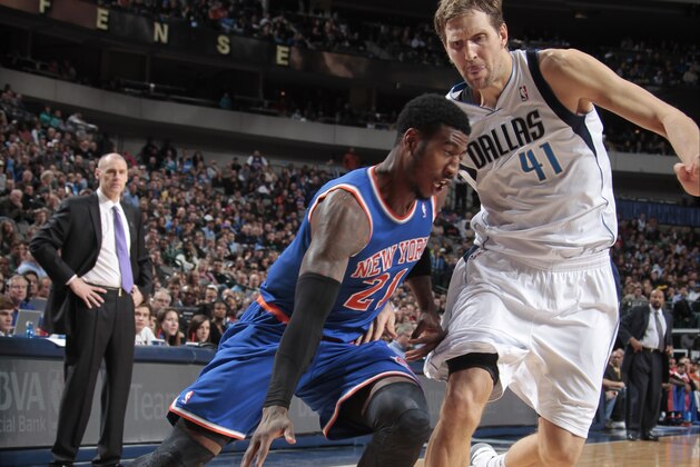 DALLAS, TX - JANUARY 5: Iman Shumpert #21 of the New York Knicks drives against Dirk Nowitzki #41 of the Dallas Mavericks on January 5, 2014 at the American Airlines Center in Dallas, Texas. NOTE TO USER: User expressly acknowledges and agrees that, by downloading and or using this photograph, User is consenting to the terms and conditions of the Getty Images License Agreement. Mandatory Copyright Notice: Copyright 2014 NBAE (Photo by Danny Bollinger/NBAE via Getty Images)