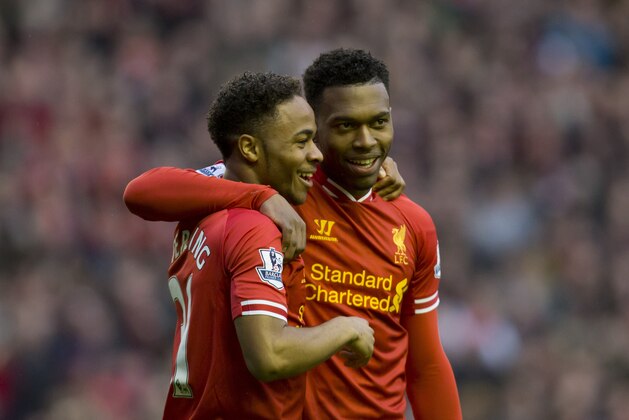 Liverpool's Daniel Sturridge, right, celebrates with teammate Raheem Sterling after scoring against Swansea City's during their English Premier League soccer match at Anfield Stadium, Liverpool, England, Sunday Feb. 23, 2014. (AP Photo/Jon Super)