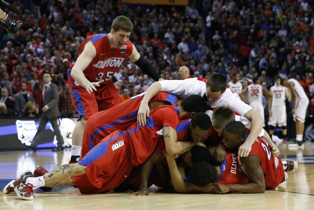 Mar 20, 2014; Buffalo, NY, USA;  Dayton Flyers celebrate after beating Ohio State Buckeyes in the men's college basketball game during the second round of the 2014 NCAA Tournament at First Niagara Center. Mandatory Credit: Kevin Hoffman-USA TODAY Sports