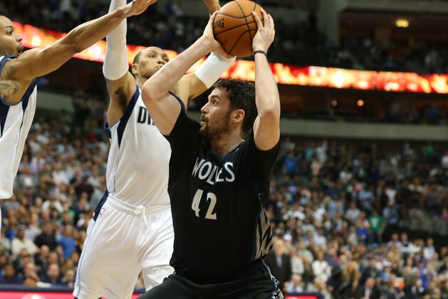 Mar 19, 2014; Dallas, TX, USA; Minnesota Timberwolves forward Kevin Love (42) splits a boucle team in overtime against  Dallas Mavericks forward Shawn Marion (0) and guard Devin Harris (20) at American Airlines Center. The Timberwolves beat the Mavs 123-122 in overtime. Mandatory Credit: Matthew Emmons-USA TODAY Sports