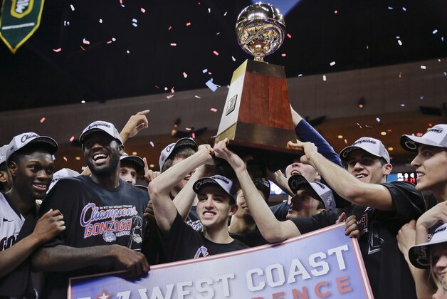 Gonzaga players hold up the championship trophy after defeating BYU 75-64 in an NCAA college basketball game for the West Coast Conference men's tournament title, Tuesday, March 11, 2014, in Las Vegas. (AP Photo/Julie Jacobson)