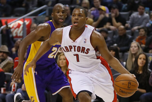 Jan 19, 2014; Toronto, Ontario, CAN; Toronto Raptors guard Kyle Lowry (7) carries the ball past Los Angeles Lakers guard Jodie Meeks (20) during the first half at the Air Canada Centre. Mandatory Credit: John E. Sokolowski-USA TODAY Sports