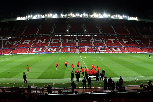Olympiakos players gather on the pitch to train at Old Trafford Stadium, Manchester, England, Tuesday, March 18, 2014. Olympiakos will play Manchester United in a Champions League last 16 second leg soccer match on Wednesday. (AP Photo/Jon Super)