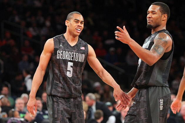 NEW YORK, NY - FEBRUARY 01:  Markel Starks #5 and D'Vauntes Smith-Rivera #4 of the Georgetown Hoyas cheer on the court during their win over the Michigan State Spartans during the game at Madison Square Garden on February 1, 2014 in New York City.  (Photo by Nate Shron/Getty Images)