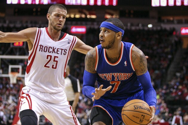 Jan 3, 2014; Houston, TX, USA; New York Knicks small forward Carmelo Anthony (7) drives the ball during the fourth quarter as Houston Rockets small forward Chandler Parsons (25) defends at Toyota Center. The Rockets defeated the Knicks 102-100. Mandatory Credit: Troy Taormina-USA TODAY Sports