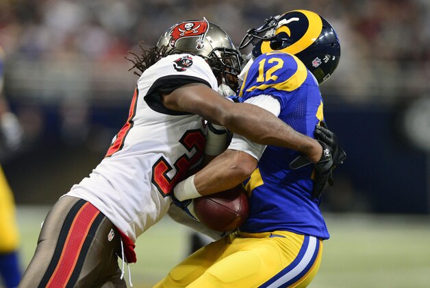 Dec 22, 2013; St. Louis, MO, USA; Tampa Bay Buccaneers free safety Dashon Goldson (38) hits St. Louis Rams wide receiver Stedman Bailey (12) during the second half at the Edward Jones Dome. The Rams defeated the Buccaneers 23-13. Mandatory Credit: Jeff Curry-USA TODAY Sports