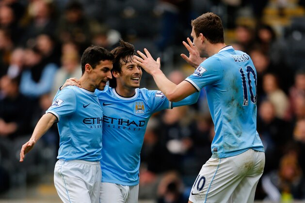 HULL, ENGLAND - MARCH 15: Edin Dzeko (R) of Manchester City celebrates his goal with team mates Jesus Navas (L) and David Silva during the Barclays Premier League match between Hull City and Manchester City at the KC Stadium on March 15, 2014 in Hull, England. (Photo by Paul Thomas/Getty Images)