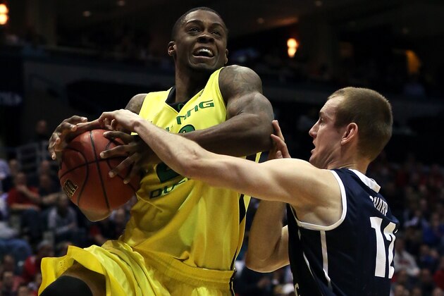 MILWAUKEE, WI - MARCH 20:  Elgin Cook #23 of the Oregon Ducks is fouled by Josh Sharp #12 of the Brigham Young Cougars during the second round game of NCAA Basketball Tournament at BMO Harris Bradley Center on March 20, 2014 in Milwaukee, Wisconsin.  (Photo by Jonathan Daniel/Getty Images)